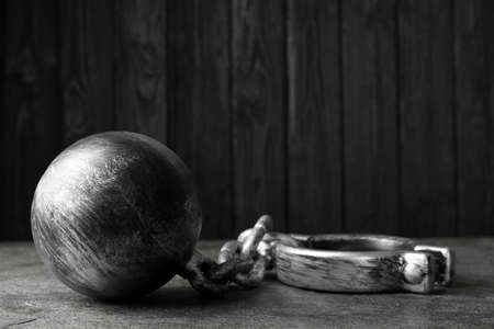 Prisoner ball with chain on gray tableの写真素材