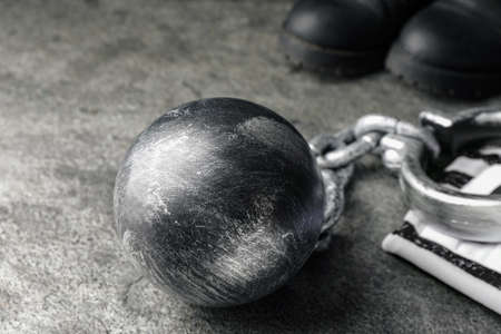 Prisoner ball with chain on gray table