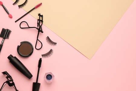 Flat lay composition with eyelash curler, makeup products and accessories on color background. Space for textの写真素材
