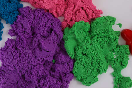 Colorful kinetic sand on white table, flat layの写真素材