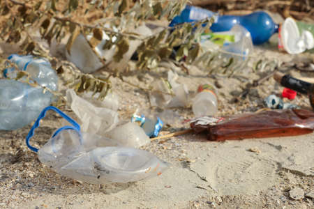 Garbage scattered on beach. Environment pollution problem