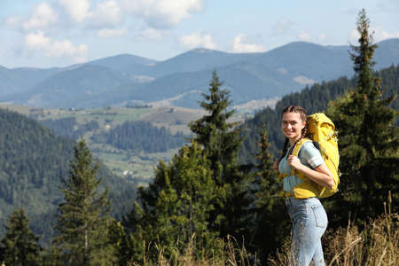 Tourist with backpack in mountains on sunny dayの写真素材