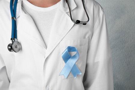 Doctor with light blue awareness ribbon, closeupの写真素材