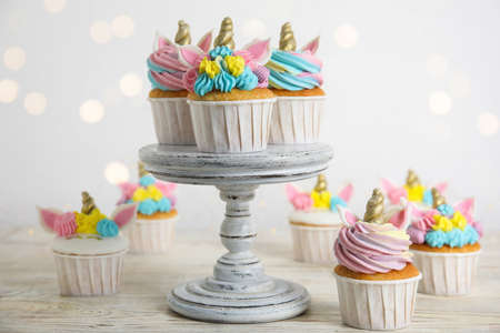 Cute sweet unicorn cupcakes on white wooden tableの写真素材