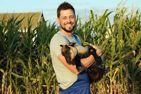 Man with goat at farm. Animal husbandryの写真素材