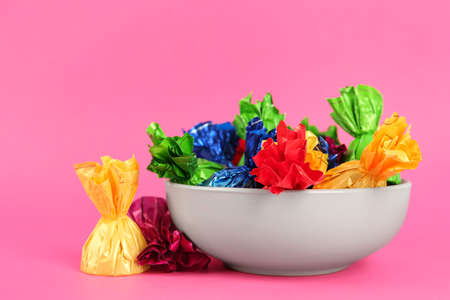 Candies in colorful wrappers on pink background, closeupの写真素材