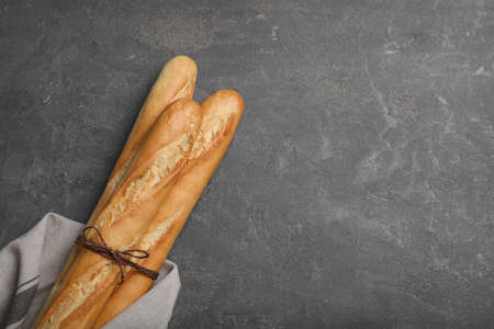 Tasty baguettes on gray table, top view. Space for textの写真素材