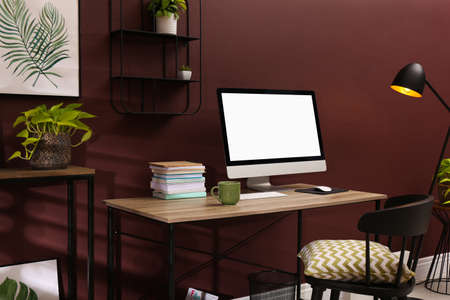 Comfortable workplace with modern computer and stylish furniture in room. Interior designの写真素材