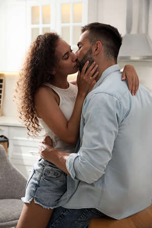 Lovely couple enjoying time together in kitchen