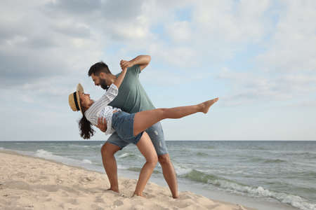 Lovely couple dancing on beach. Time togetherの写真素材
