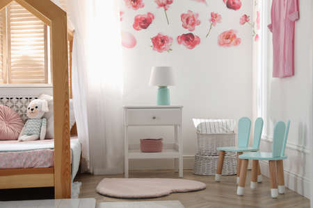 Stylish child room interior with wooden house bedの写真素材