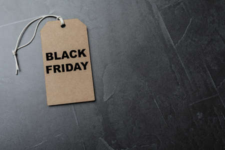 Tag with words Black Friday on gray table, top view. Space for text