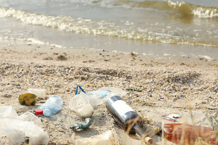 Garbage scattered on beach. Environment pollution problem