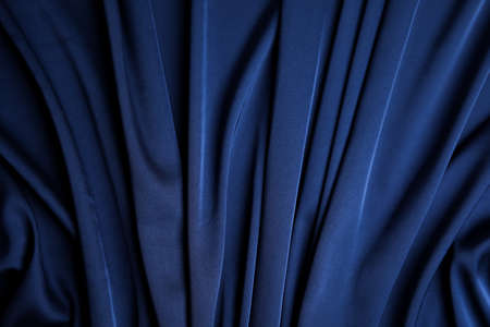 Crumpled dark blue silk fabric as background, top viewの写真素材