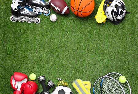 Different sport equipment on green grass, flat lay. Space for textの写真素材