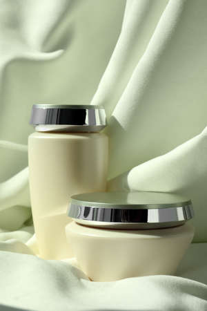 Hair care cosmetic products on light green fabricの写真素材