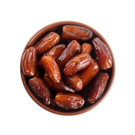 Sweet dried dates in bowl on white background, top view