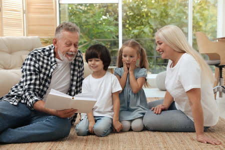 Grandparents spending time with their grandchildren at homeの写真素材