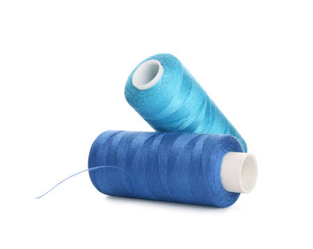 Different colorful sewing threads on white background