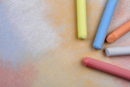 Colorful pastel chalks on abstract drawing, flat lay. Space for textの写真素材