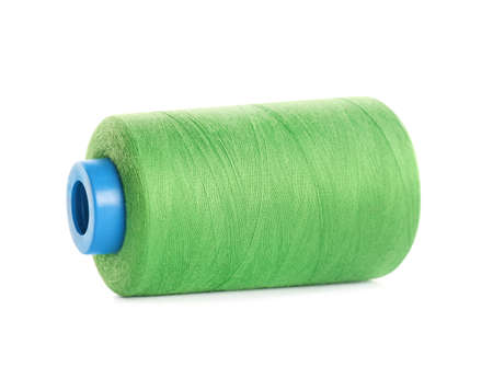 Spool of green sewing thread isolated on white