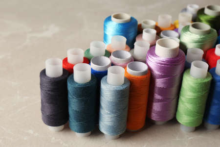 Set of color sewing threads on light gray table