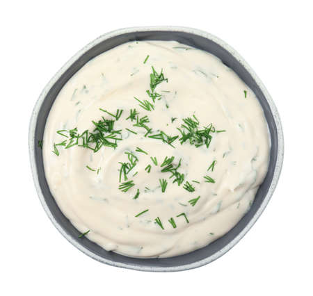 Tasty creamy dill sauce in bowl isolated on white, top viewの写真素材