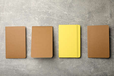Different planners on gray table, flat lay