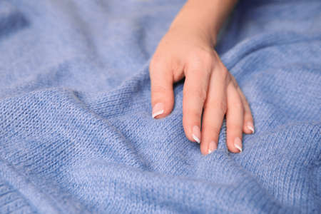 Woman touching soft blue fabric, closeup viewの写真素材
