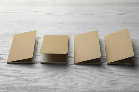Modern kraft planners on white wooden table