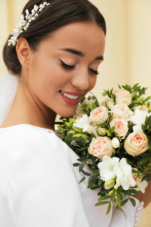 Young bride with beautiful wedding bouquet outdoorsの写真素材
