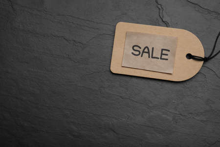 Tag with word Sale on dark stone table, top view and space for text. Black Fridayの写真素材