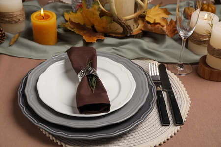 Beautiful autumn place setting and decor for festive dinner on table
