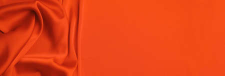 Orange silk fabric as background, top view with space for text. Banner designの写真素材