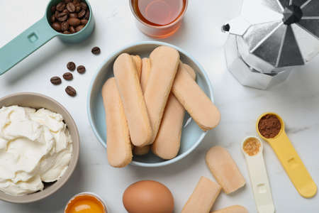 Flat lay composition with ingredients for tiramisu on white tableの写真素材