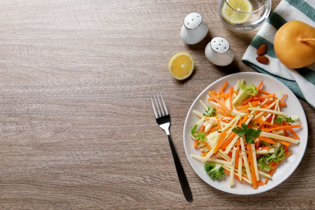 Fresh turnip salad served on wooden table, flat lay. Space for textの写真素材