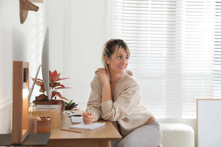 Woman at workplace in room. Interior designの写真素材
