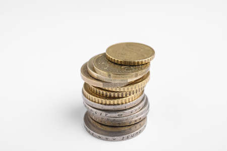 Many Euro coins stacked on white background, closeupの写真素材