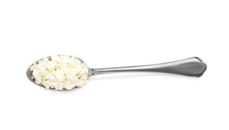 Delicious fresh cottage cheese in spoon isolated on white, top viewの写真素材