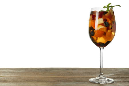 Glass of Red Sangria on wooden table against white background. Space for textの写真素材