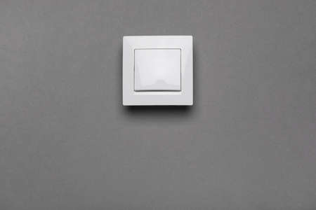 White light switch on gray background. Space for text