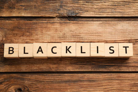 Cubes with word Blacklist on wooden background, flat layの写真素材