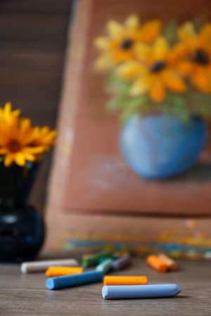 Set of colorful pastels and blurred view of beautiful drawing on backgroundの写真素材