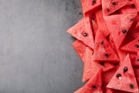 Delicious fresh watermelon slices on gray table, flat lay. Space for text