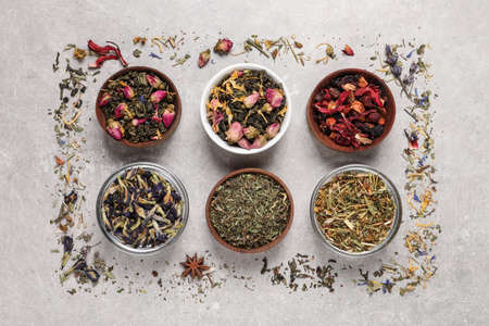 Flat lay composition with different dry teas on light tableの写真素材