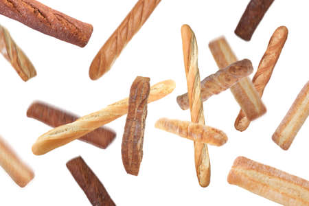 Freshly baked tasty baguettes falling on white backgroundの写真素材