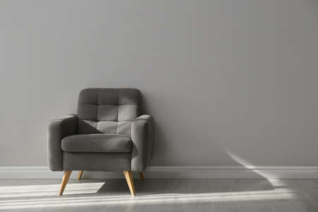Stylish armchair near gray wall, space for text. Interior elementの写真素材