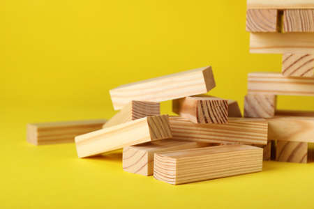 Wooden blocks on yellow background, closeupの写真素材