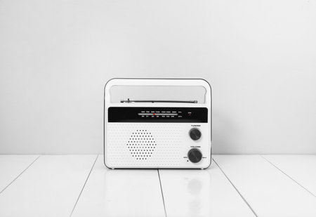 Retro radio receiver on white wooden tableの写真素材