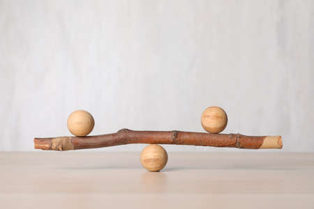 Tree branch with wooden balls on table, space for text. Harmony and balance conceptの写真素材